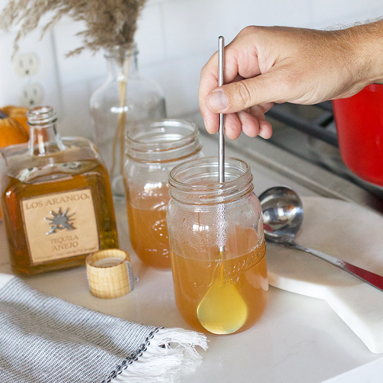 Mason jar and spiked cider being mixed