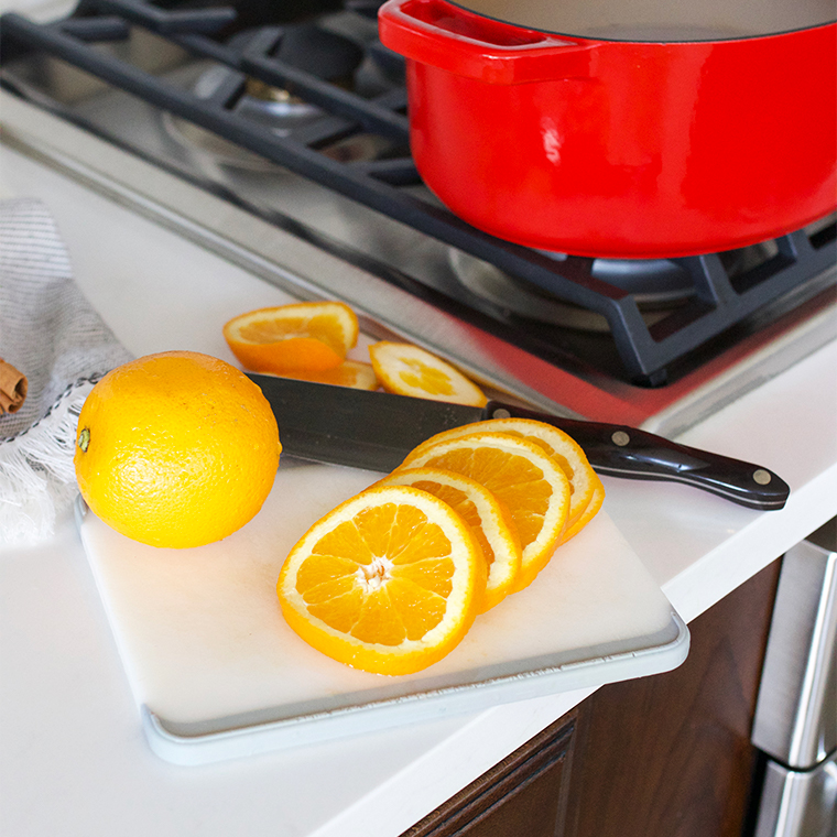 cutting board and knife with orange rounds
